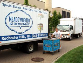 Delivering an ice cream cart Delivery person pushing an ice cream cart