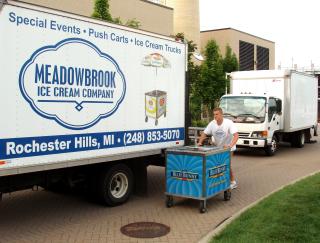 Delivery person pushing an ice cream cart